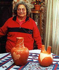 Anna Mitchell displays a wedding vessel, right, and relief melon pot. 